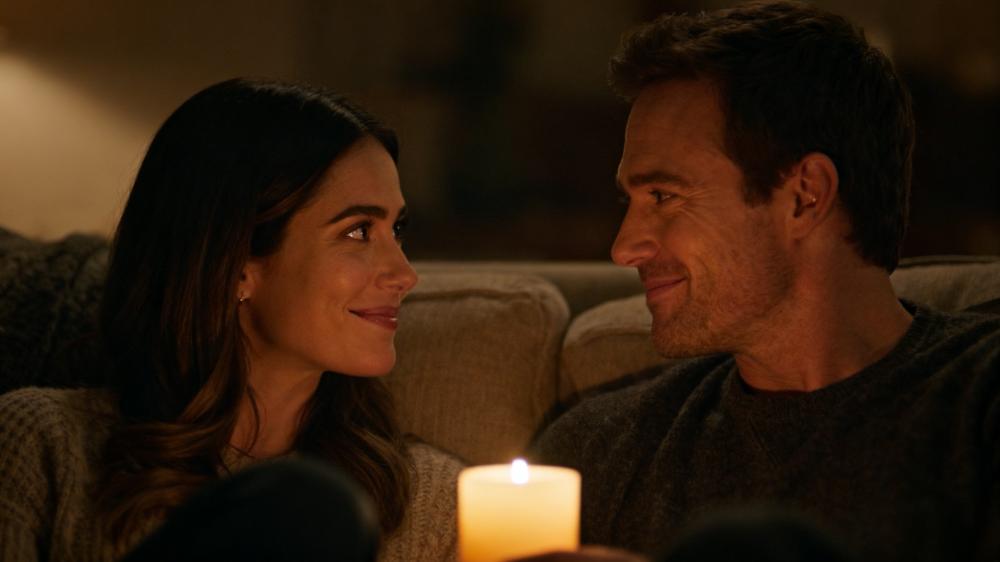 A couple engaging in a connection game for couples, having a heartfelt conversation by candlelight, deepening their intimacy.